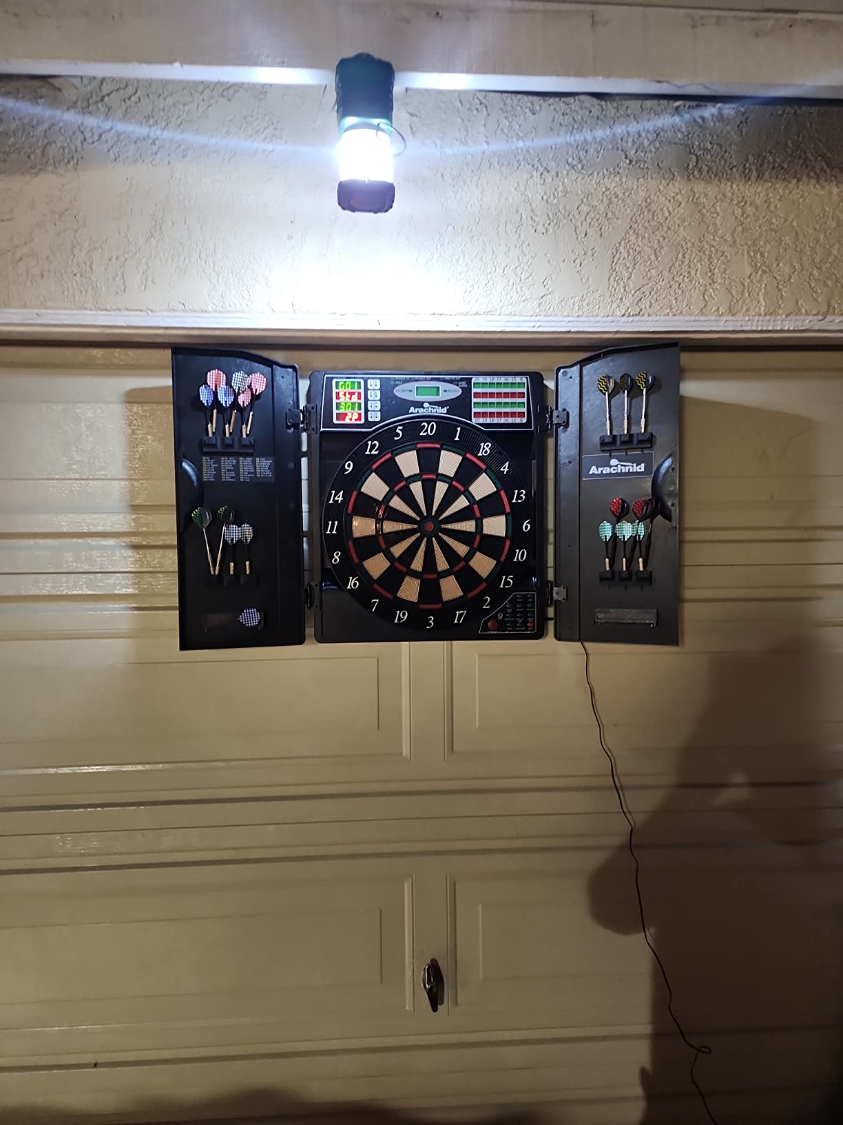 Arachnid Titanium 5400: 13.5 inch Target with Integrated Cabinet. Offers 38 Games, 316 Variations, Color LED Scoring, and Solo Play. Includes Double in/Out Modes for Competitive Game Room Fun. customer photo 1